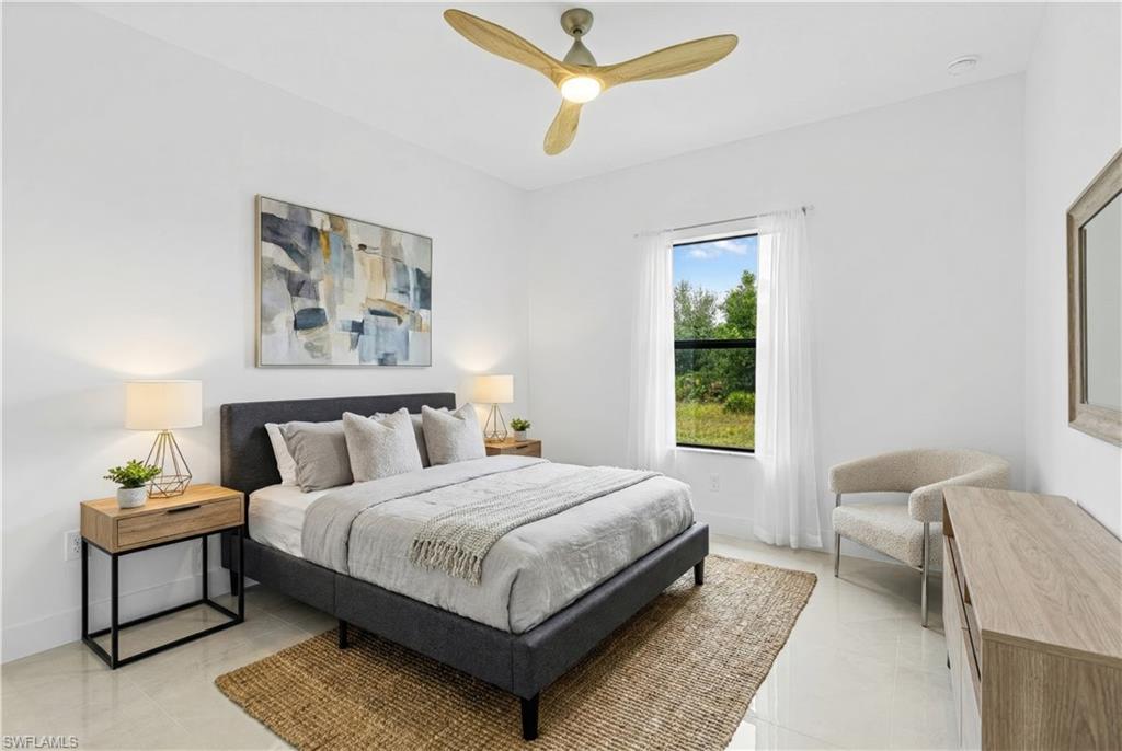 343 Pullman Street Lehigh Acres, FL 33974 - Photo 26 of 43 a bedroom with a bed a couch and a window