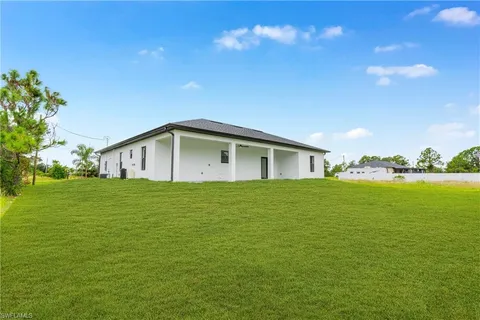 a house view with swimming pool in front of it
