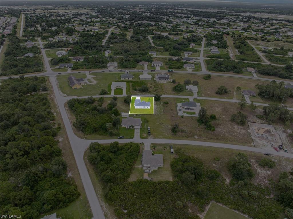 343 Pullman Street Lehigh Acres, FL 33974 - Photo 40 of 43 an aerial view of residential houses with outdoor space