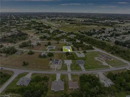 an aerial view of residential houses with outdoor space and swimming pool
