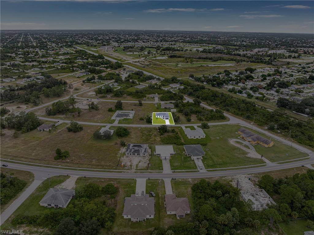 343 Pullman Street Lehigh Acres, FL 33974 - Photo 42 of 43 an aerial view of residential houses with outdoor space
