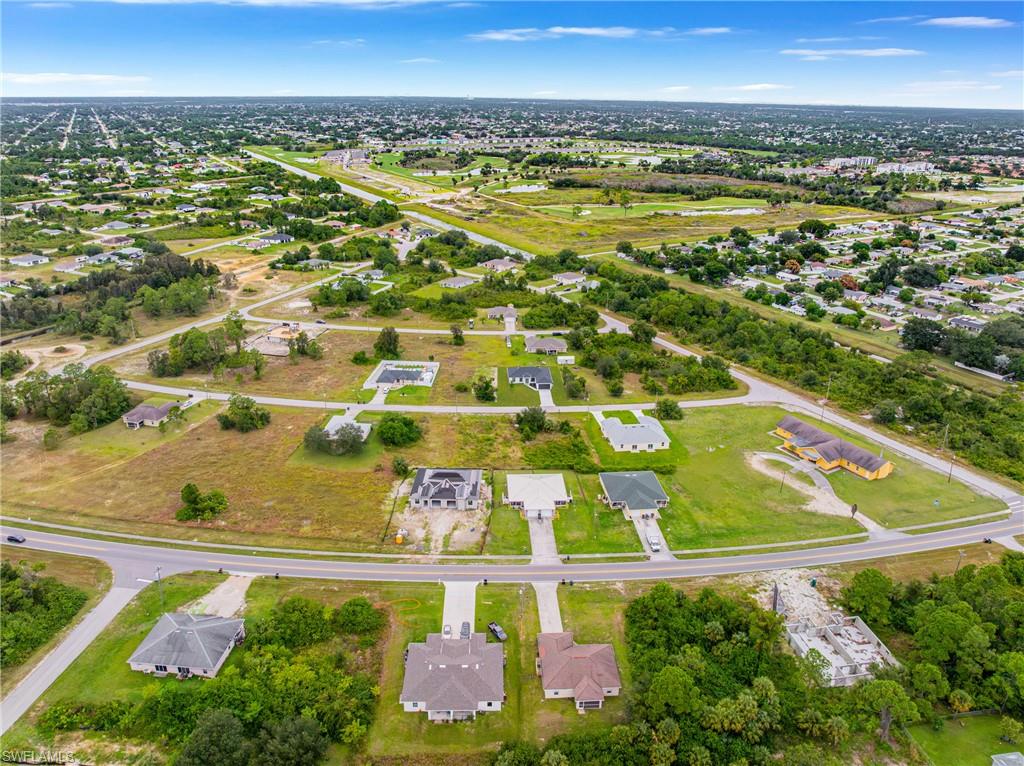 343 Pullman Street Lehigh Acres, FL 33974 - Photo 43 of 43 an aerial view of residential houses with outdoor space and swimming pool