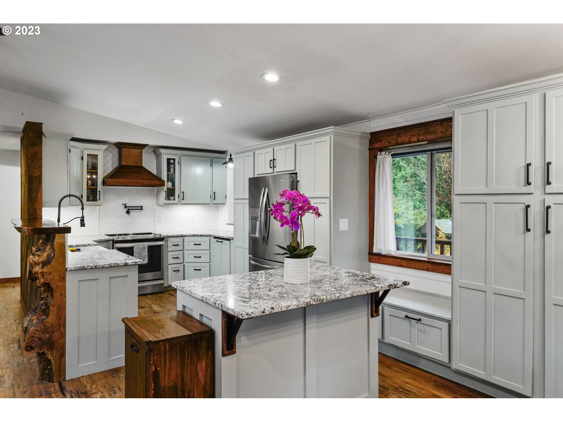 54795 Southwest Hebo Road Grand Ronde, OR 97347 - Photo 11 of 41 a kitchen with granite countertop kitchen island stainless steel appliances a sink stove and refrigerator