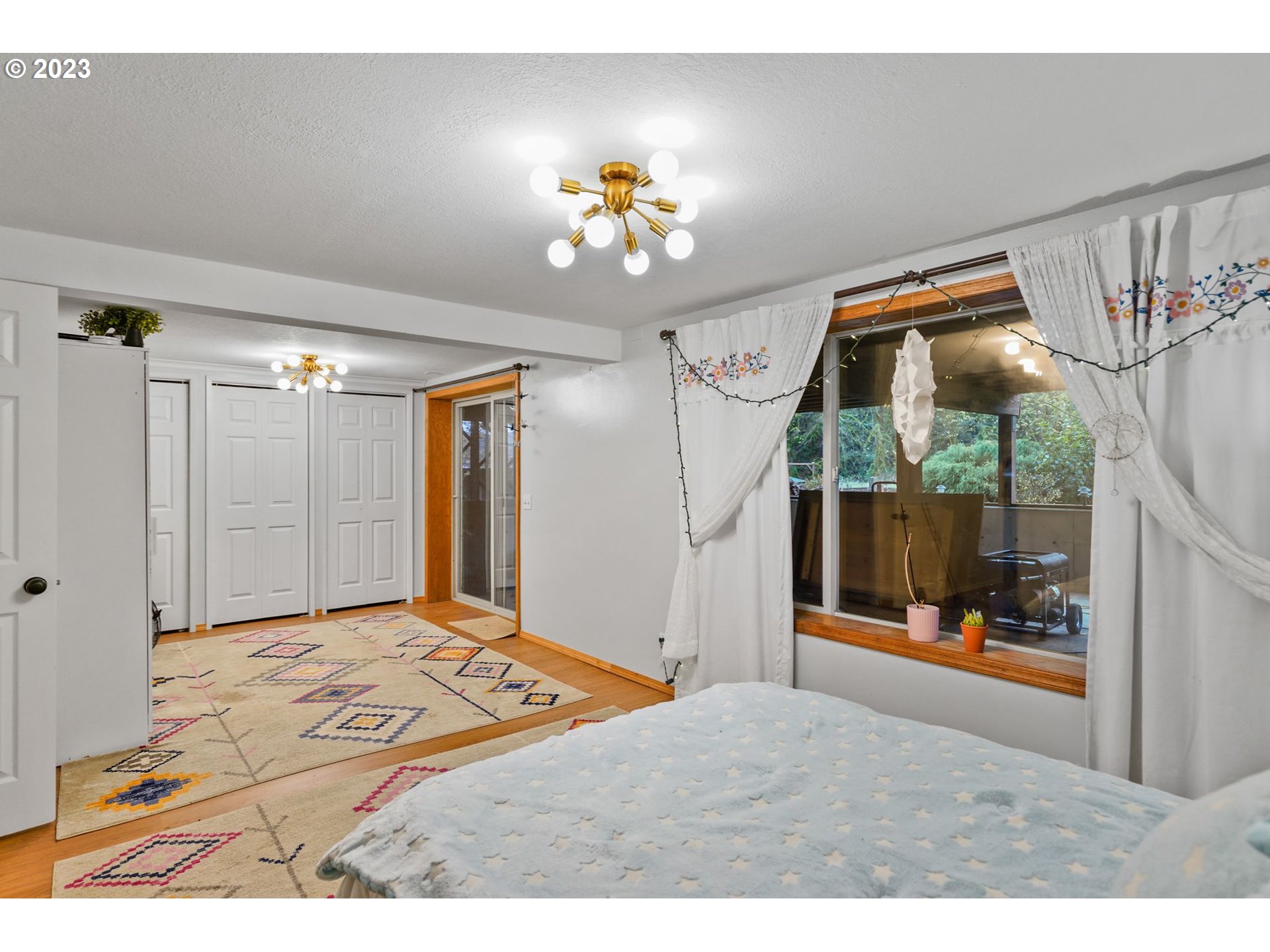 54795 Southwest Hebo Road Grand Ronde, OR 97347 - Photo 24 of 41 a bedroom with a bed mirror and a window