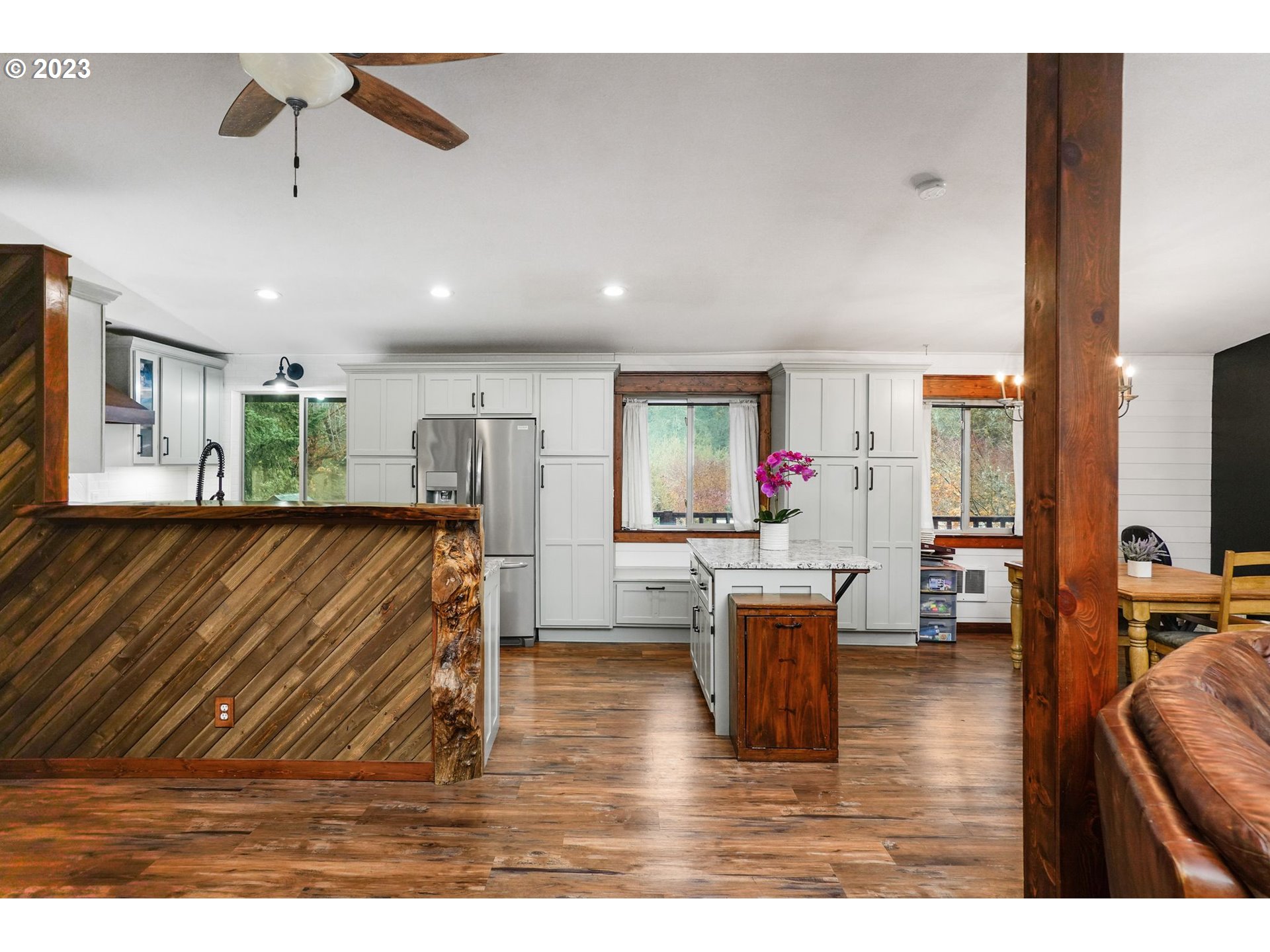 54795 Southwest Hebo Road Grand Ronde, OR 97347 - Photo 6 of 41 a living room with kitchen island furniture and a wooden floor