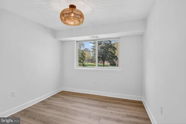 a view of a room with wooden floor and window