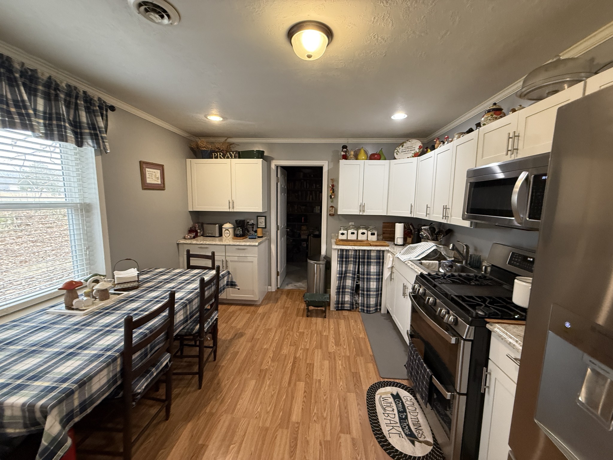 201 South Point Drive Camden, TN 38320 - Photo 23 of 30 a kitchen with granite countertop a stove a sink a refrigerator and wooden cabinets