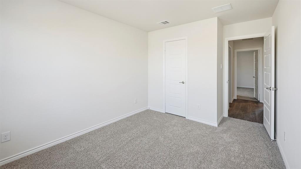 403 Flintlock Road Caddo Mills, TX 75135 - Photo 10 of 26 Unfurnished bedroom with light colored carpet and baseboards