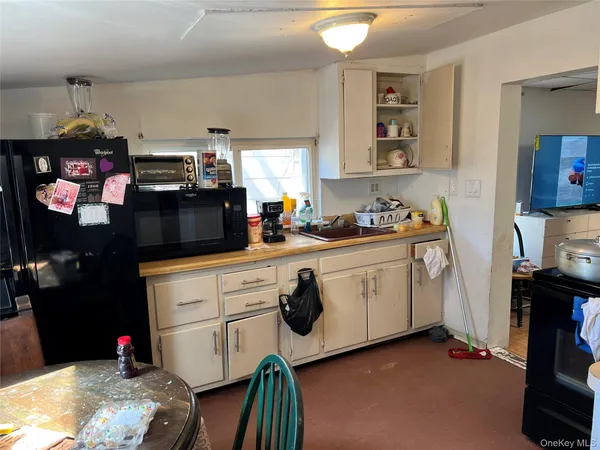 a kitchen with sink cabinets and stove top oven
