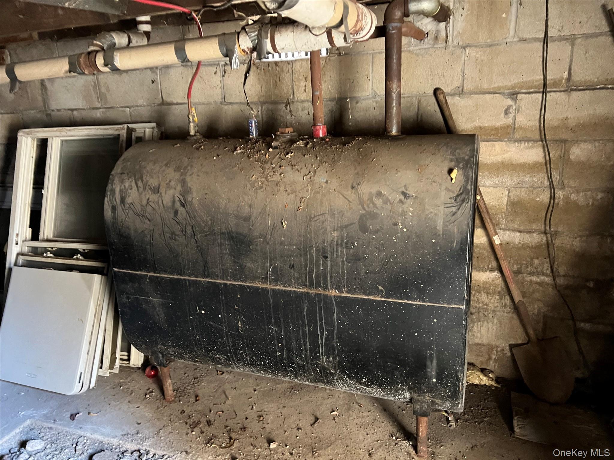 73 Raynor Street Freeport, NY 11520 - Photo 8 of 11 a room with water heater and wooden floor