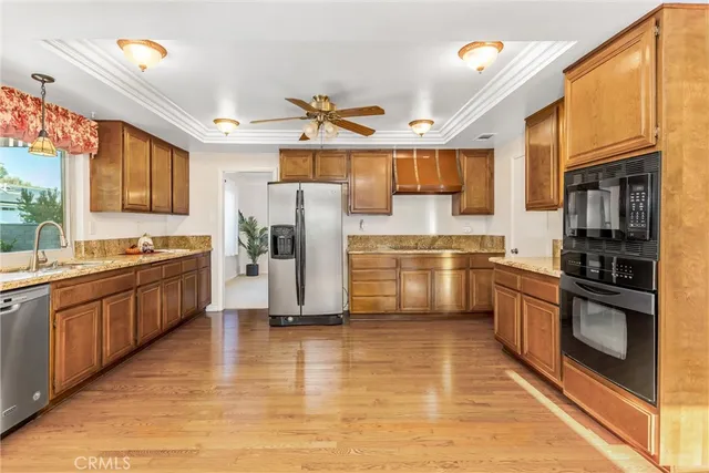a kitchen with a refrigerator and a stove top oven