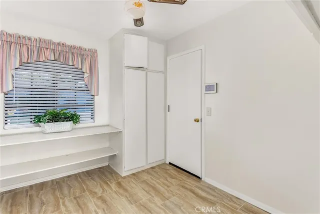 a bathroom with a granite countertop sink mirror vanity and toilet