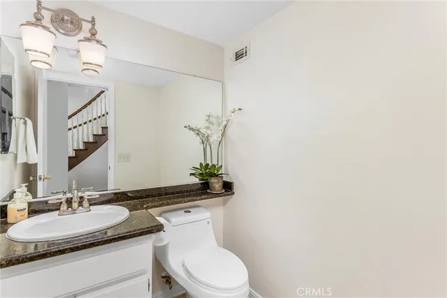 a living room with wooden floor and stairs