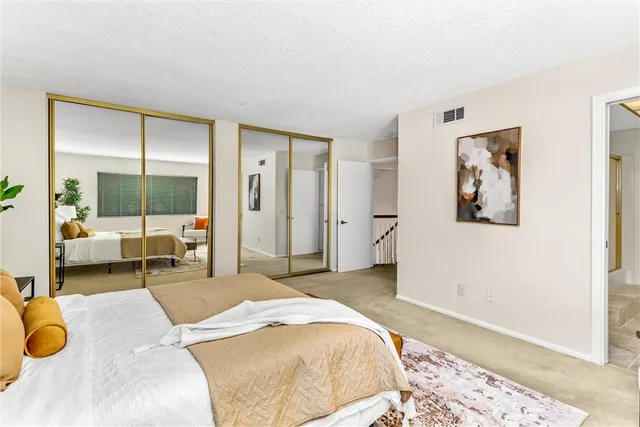 a bathroom with a granite countertop sink a mirror and a shower