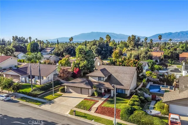 an aerial view of a house with a garden and swimming pool