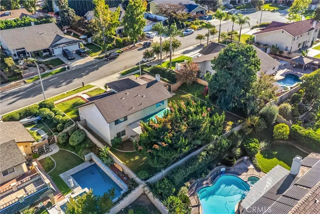 an aerial view of a house with a swimming pool yard and outdoor seating
