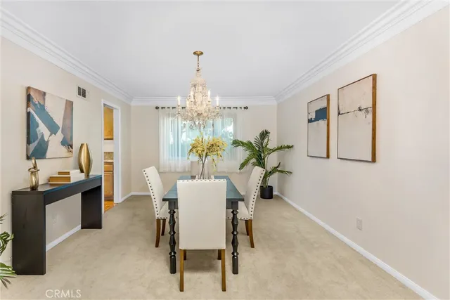 a view of a dining room with furniture and chandelier
