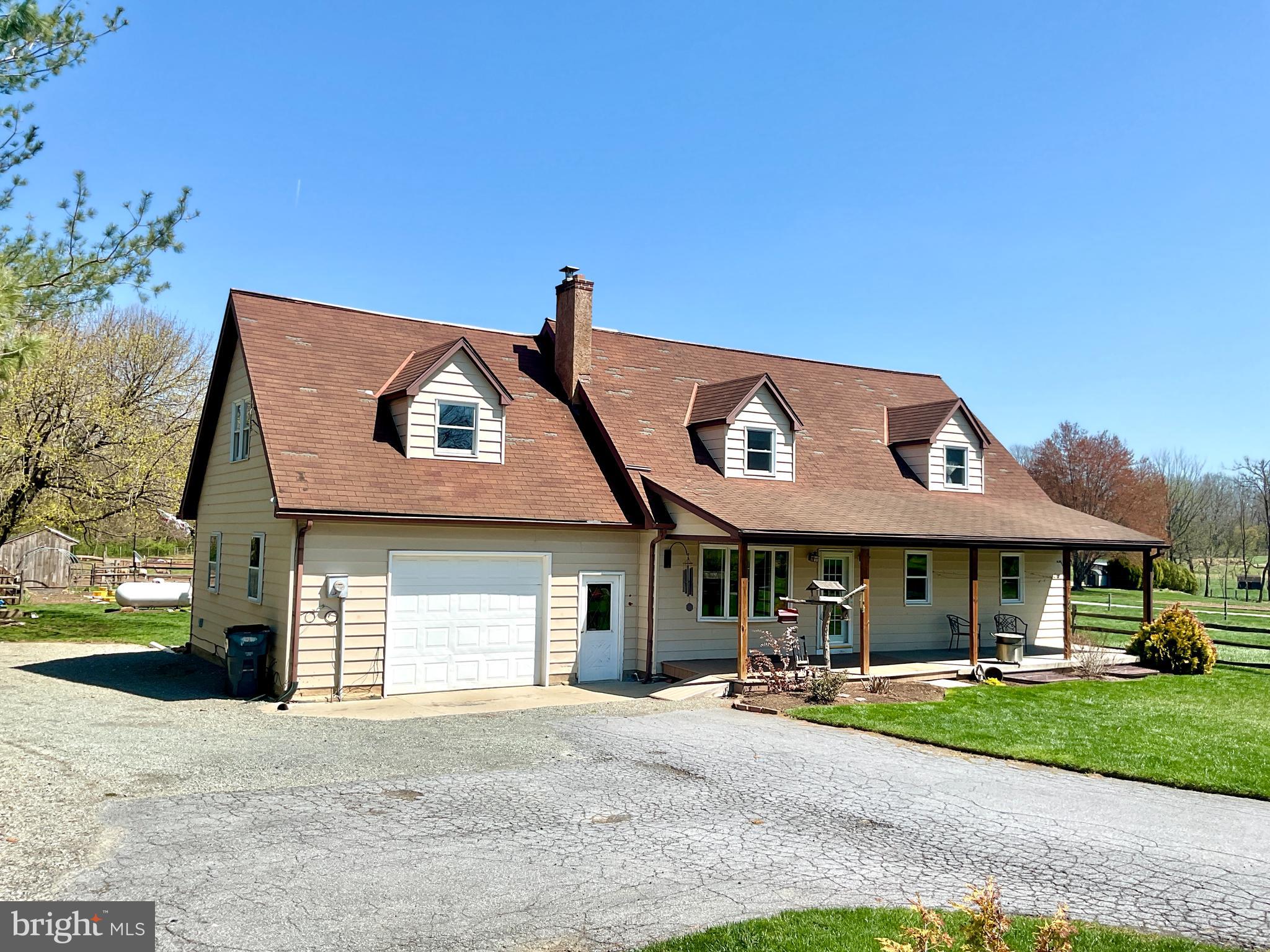 69 Fairview Road New Providence, PA 17560 - Photo 2 of 59 a front view of a house with a garden and porch