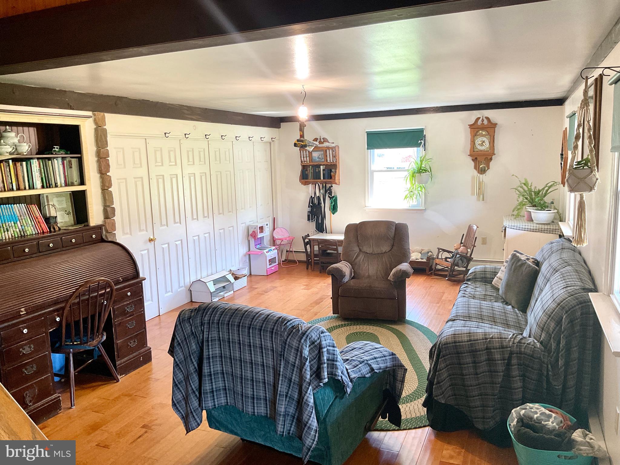 69 Fairview Road New Providence, PA 17560 - Photo 48 of 59 a living room with furniture a bookshelf and a window