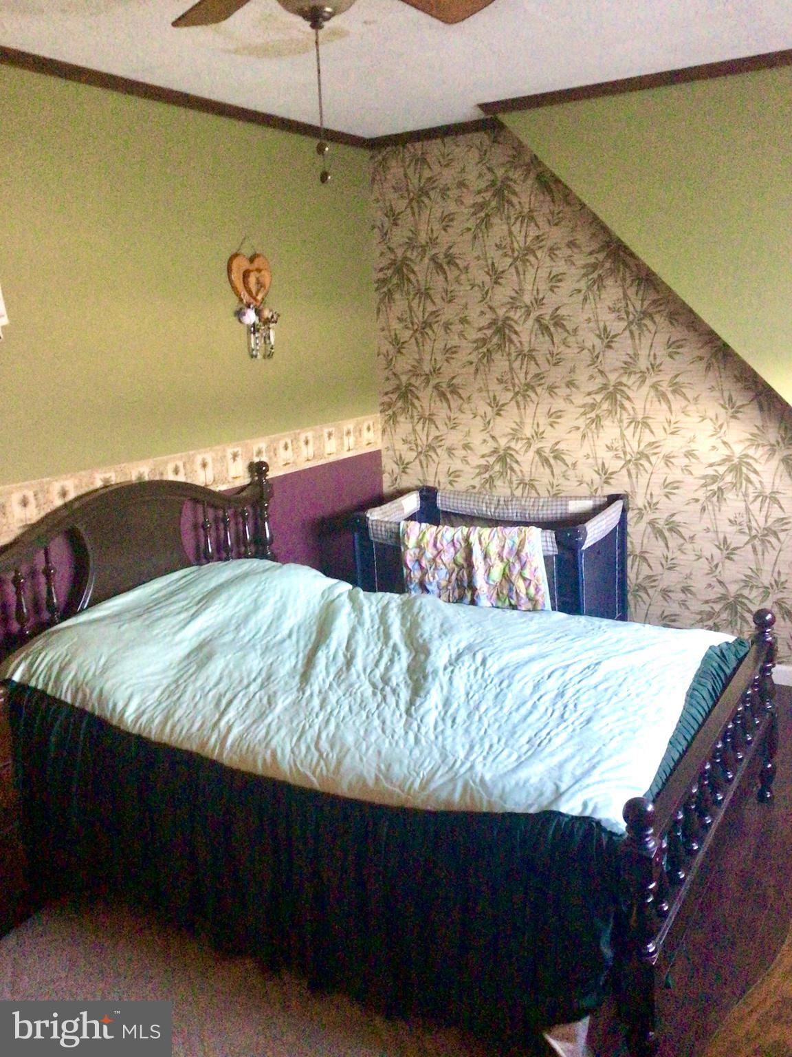 69 Fairview Road New Providence, PA 17560 - Photo 52 of 59 a bed sitting in a bedroom next to a wall