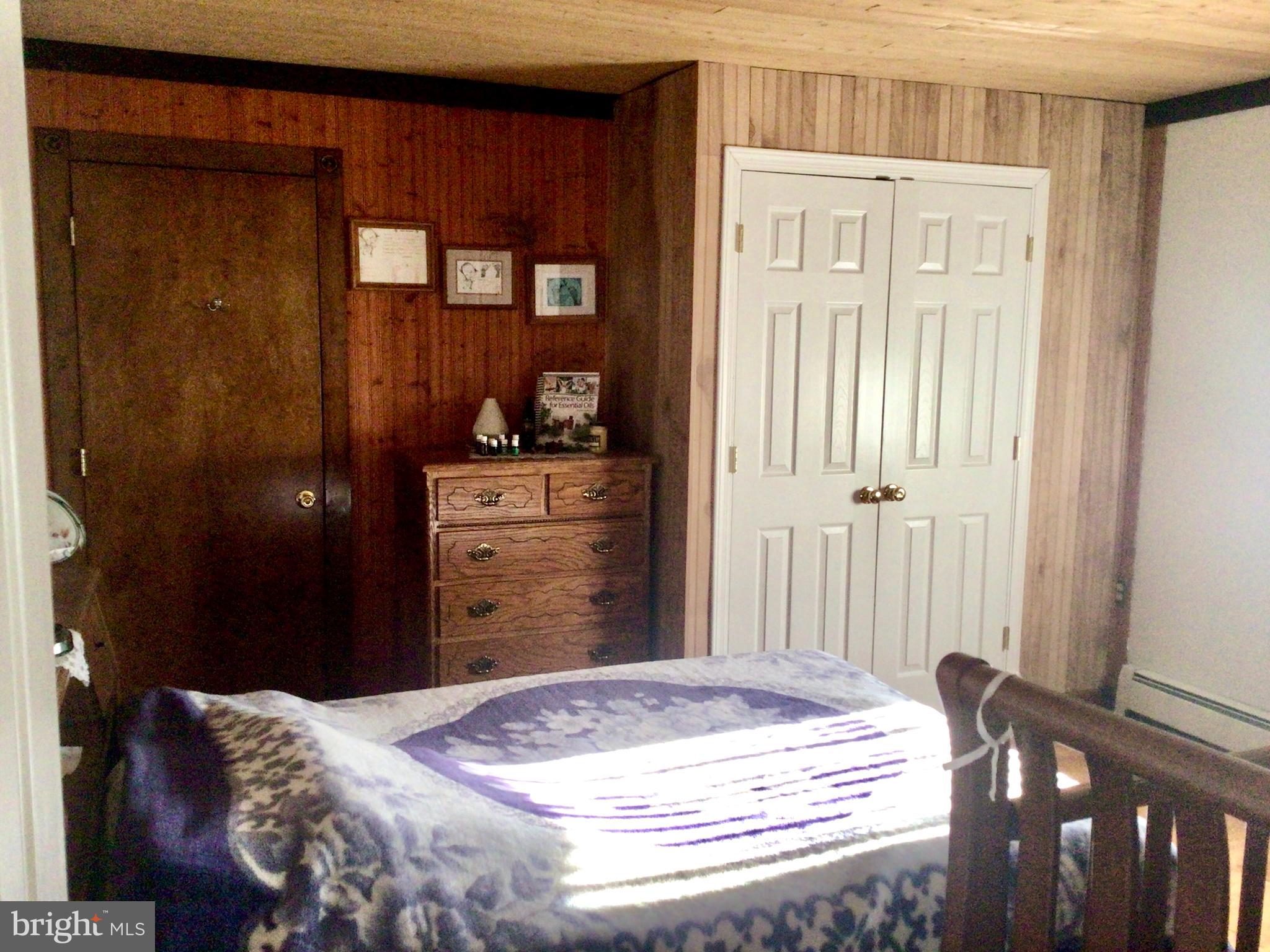 69 Fairview Road New Providence, PA 17560 - Photo 56 of 59 a bed room with a bed and a mirror