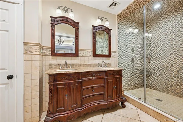 a bathroom with a bathtub sink vanity and mirror