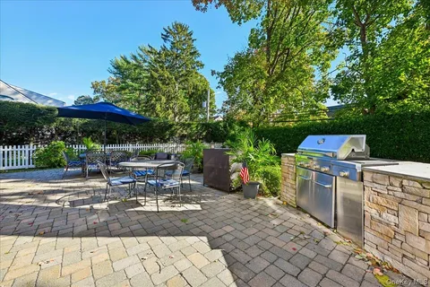 a view of a chairs and table under an umbrella