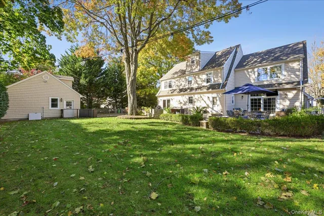 a view of house with a yard
