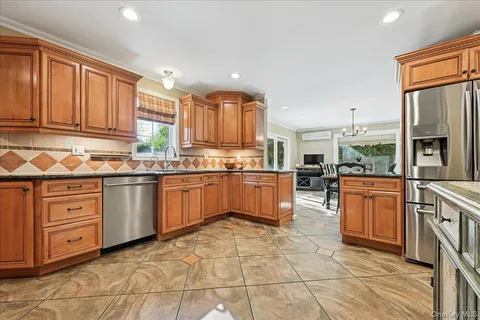 a kitchen with stainless steel appliances granite countertop a stove sink and cabinets