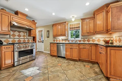 a kitchen with stainless steel appliances a stove sink and cabinets
