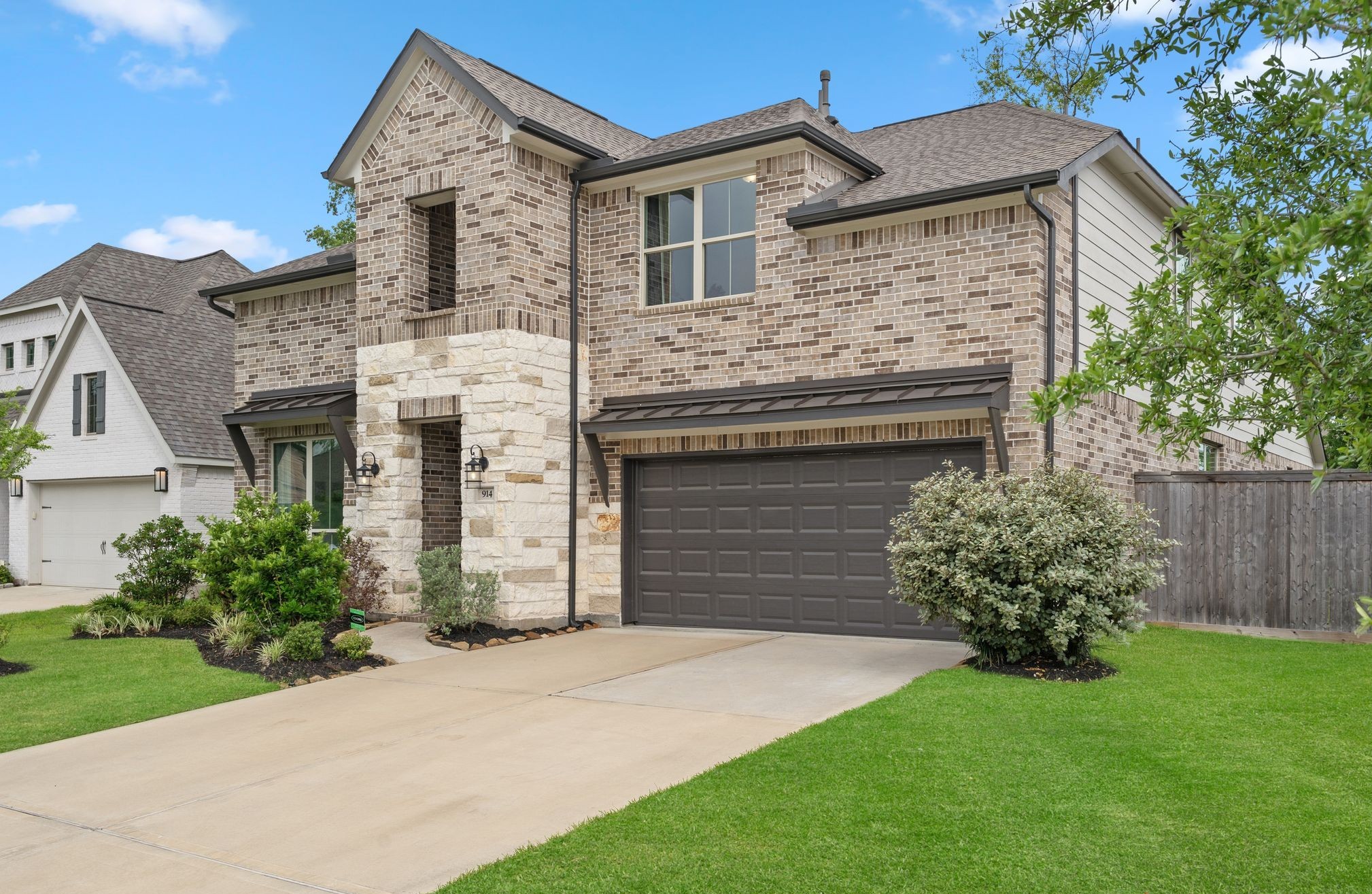 914 Sendero Trail Conroe, TX 77304 - Photo 2 of 50 Well manicured landscaping and a welcoming covered entry.