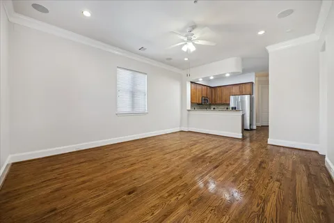 wooden floor in an empty room with a kitchen