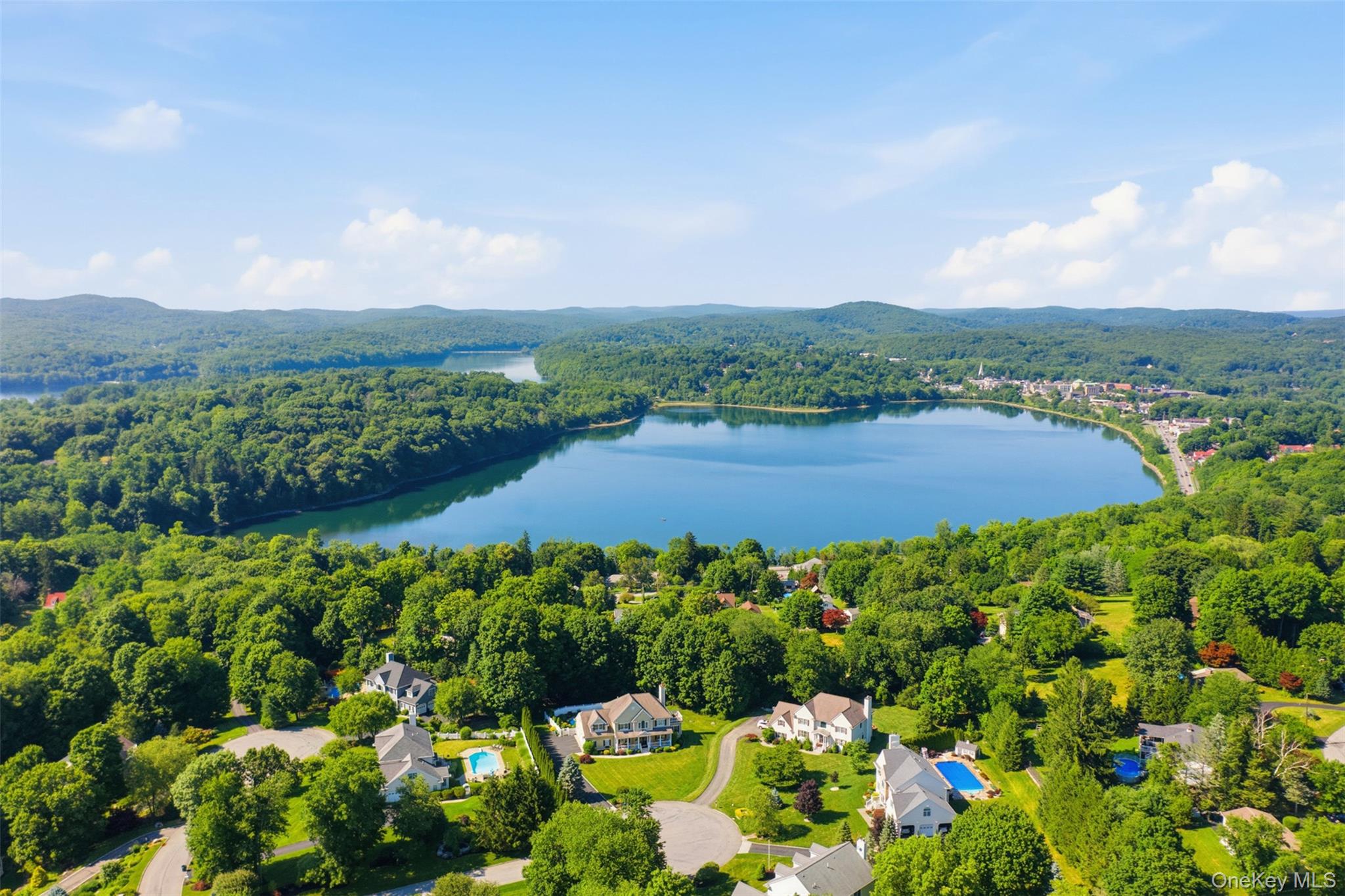 12 Leeside Road Carmel, NY 10512 - Photo 40 of 44 Aerial perspective showcasing a large body of water surrounded by expansive green landscapes and residential properties