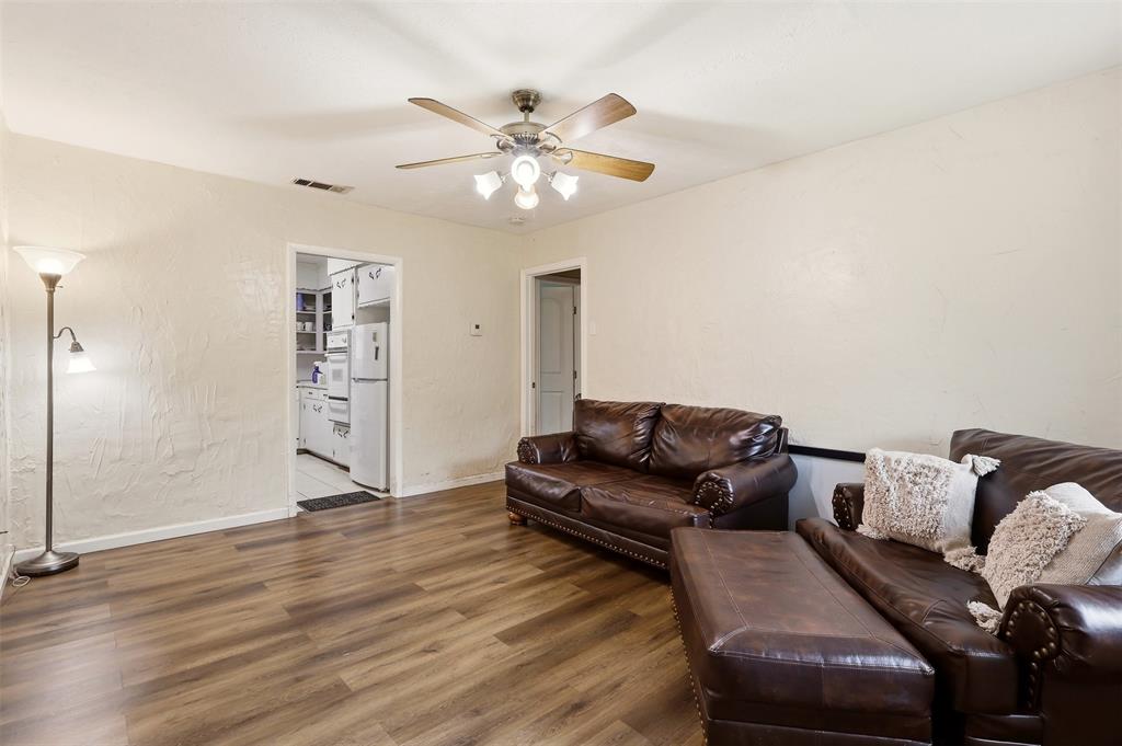 1803 Sycamore Street Commerce, TX 75428 - Photo 3 of 18 a living room with furniture and wooden floor