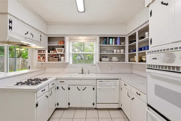 a kitchen with white cabinets and white appliances