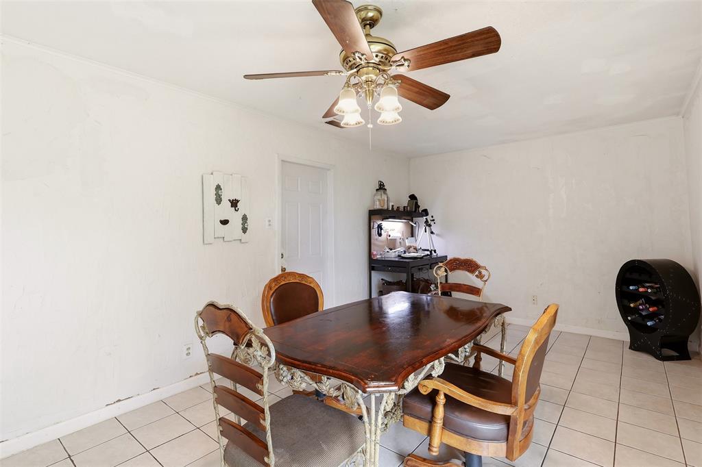 1803 Sycamore Street Commerce, TX 75428 - Photo 10 of 18 a dining room with furniture and a chandelier fan