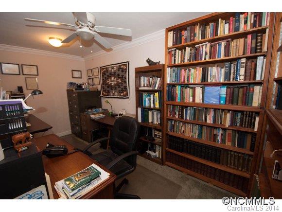 1081 Wesley Creek Road Clyde, NC 28721 - Photo 17 of 24 a living room with hard wood flooring and a book shelf