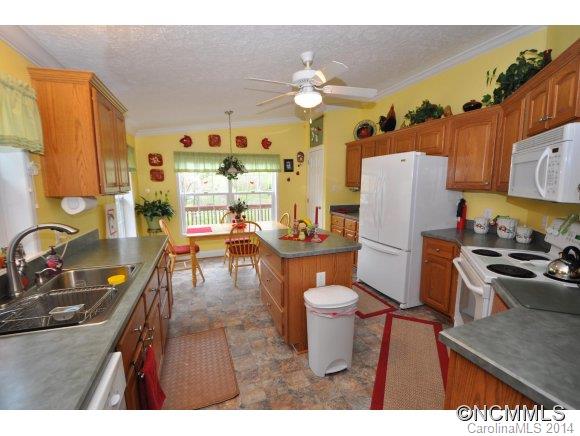 1081 Wesley Creek Road Clyde, NC 28721 - Photo 3 of 24 a kitchen with a refrigerator and a stove