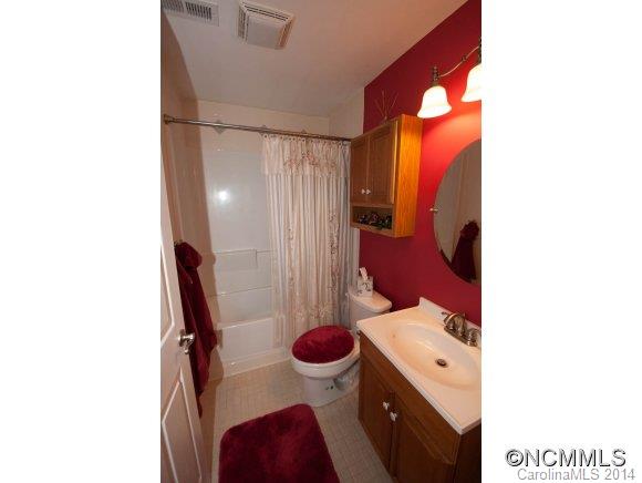 1081 Wesley Creek Road Clyde, NC 28721 - Photo 24 of 24 a bathroom with a toilet sink and mirror
