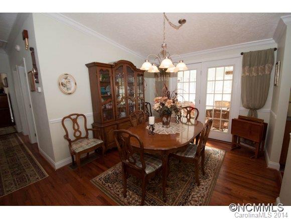 1081 Wesley Creek Road Clyde, NC 28721 - Photo 8 of 24 a view of a dining room with furniture wooden floor and chandelier
