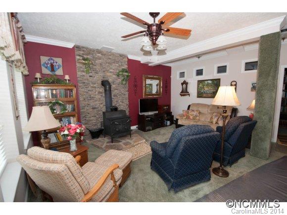 1081 Wesley Creek Road Clyde, NC 28721 - Photo 10 of 24 a living room with furniture and a chandelier