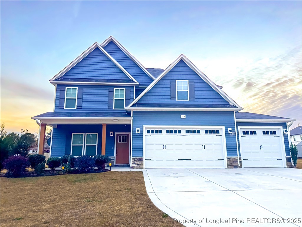a view of a house with a yard and garage