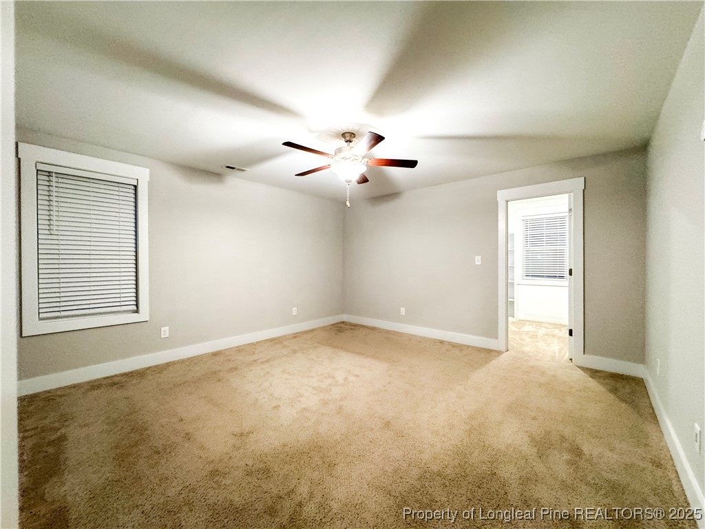 144 Deaton Road Raeford, NC 28376 - Photo 12 of 24 a view of an empty room with a ceiling fan
