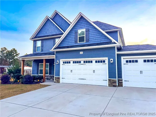 a view of a house with a yard and garage