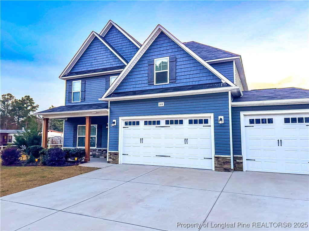 144 Deaton Road Raeford, NC 28376 - Photo 2 of 24 a view of a house with a yard and garage