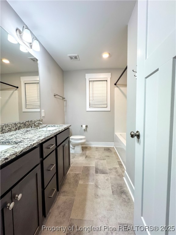 144 Deaton Road Raeford, NC 28376 - Photo 21 of 24 a bathroom with a granite countertop sink and a mirror