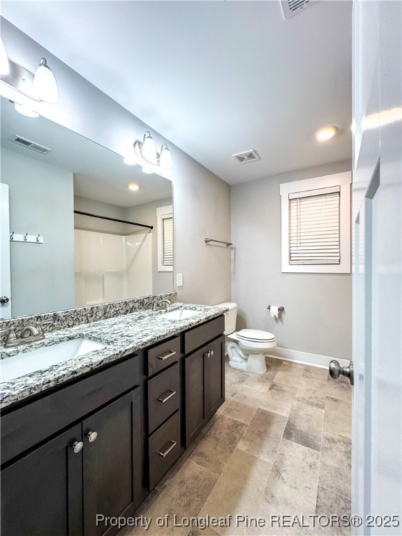 144 Deaton Road Raeford, NC 28376 - Photo 22 of 24 a bathroom with a granite countertop sink toilet and mirror