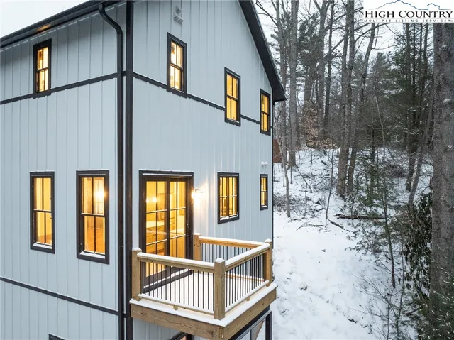 a view of a house with a wooden fence