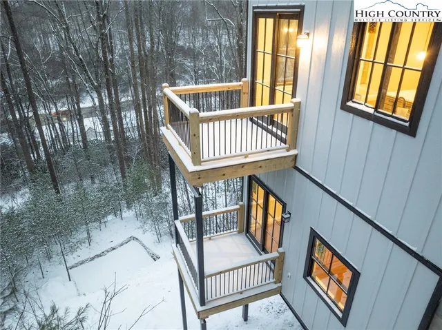 a view of an entryway with wooden floor and wooden fence