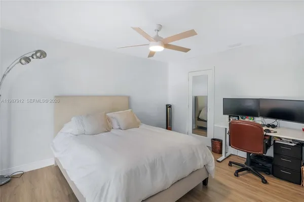 a bedroom with a bed and a desk